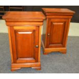 A pair of Victorian style mahogany bedside cupboards on stepped plinth bases,