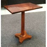 A William IV mahogany occasional table with tapered faceted support and quatre-foil base,