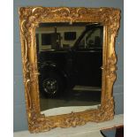 A 20th Century gilt wall mirror in a rococco style frame,