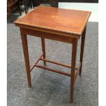 An early 20th Century mahogany fold-over card table of rectangular form with a square tapered