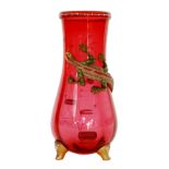 Harrach - A late 19th Century Continental ruby glass vase of fluted ovoid form raised to three spur