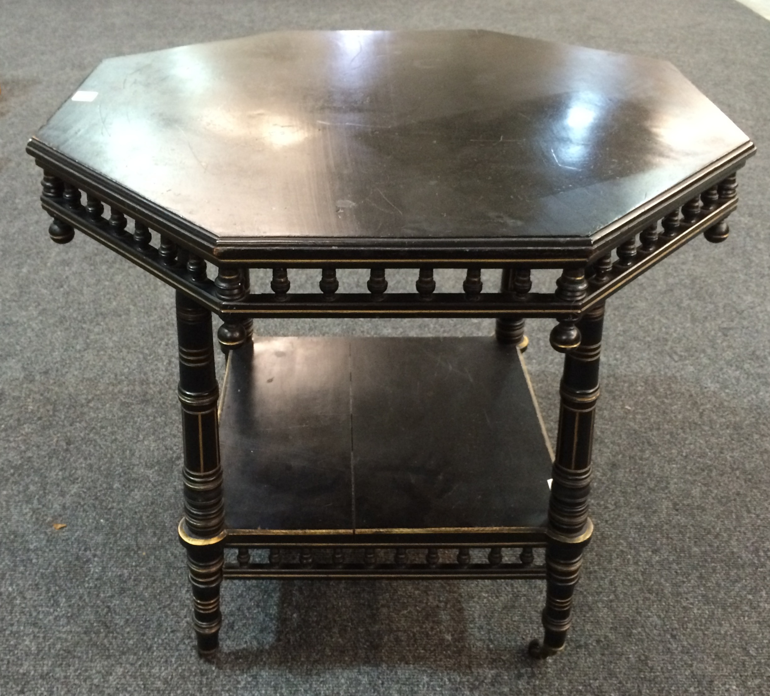 Unknown - An ebonised and gilt-highlighted occasional table of octagonal form with a spindle turned