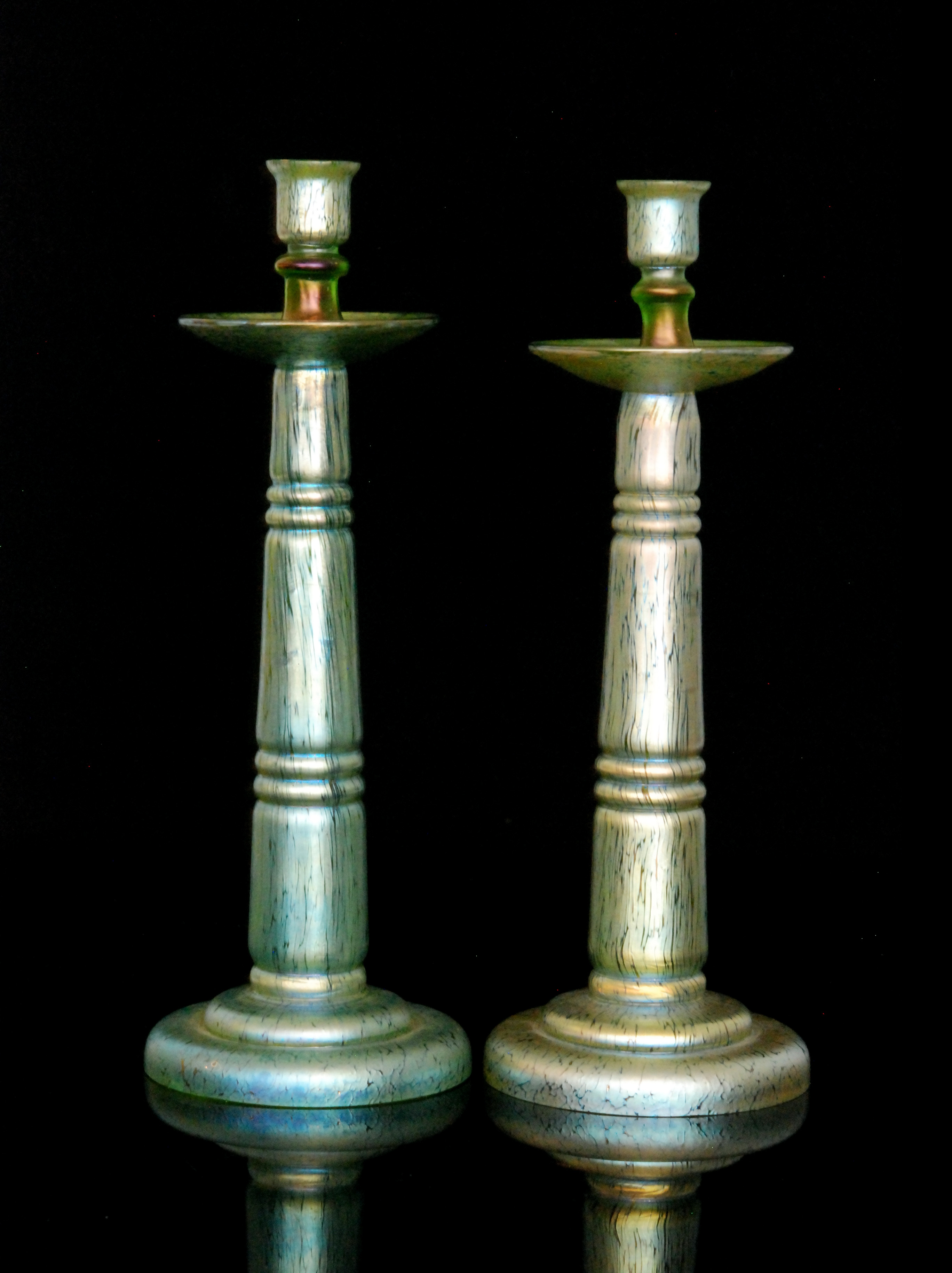 Loetz - A pair of large glass candlesticks with a stepped circular base rising to a tapered column