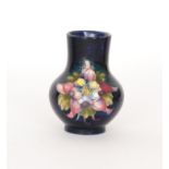 A Moorcroft vase of compressed form decorated in the Columbine pattern with tubelined flowers