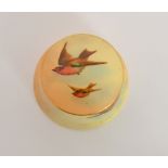 A Royal Worcester trinket box and cover decorated with two hand painted robins in flight against a