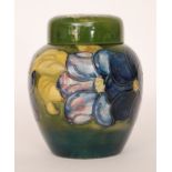 A Moorcroft ginger jar and cover decorated in the Clematis pattern with tubelined tonal crimson and