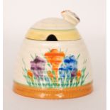 A Clarice Cliff beehive honey pot circa 1930 hand painted in the Crocus pattern with sprays of