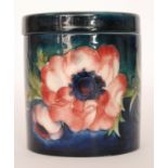 A Moorcroft Anemone pattern cylindrical pot decorated with tubelined flowers and foliage against a