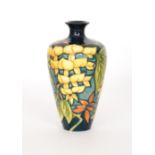 A Moorcroft Pottery Collectors Club Wisteria pattern vase decorated with trailing yellow flowers