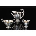 A Victorian hallmarked silver bachelor tea service comprising pedestal teapot,