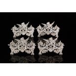 A set four Edwardian hallmarked silver menu card holders each of shaped rectangular outline with