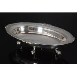 A George VI hallmarked silver oval dish raised on four paw feet, length 31.