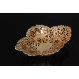 An Edwardian hallmarked silver gilt oval bon bon dish with pierced and embossed decoration