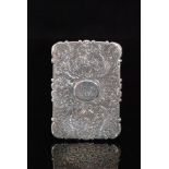 A Victorian hallmarked silver shaped rectangular card case with foliate engraved decoration to