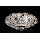 A Victorian hallmarked silver circular bowl with pierced and embossed foliate decoration within