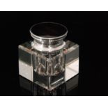 An Art Deco hallmarked silver square section inkwell with circular tortoiseshell mounted hinged