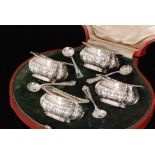 A cased set of four hallmarked silver boat shaped open salts each with part embossed fluted