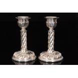 A pair of late Victorian hallmarked silver candlesticks circular bases below wrythen embossed