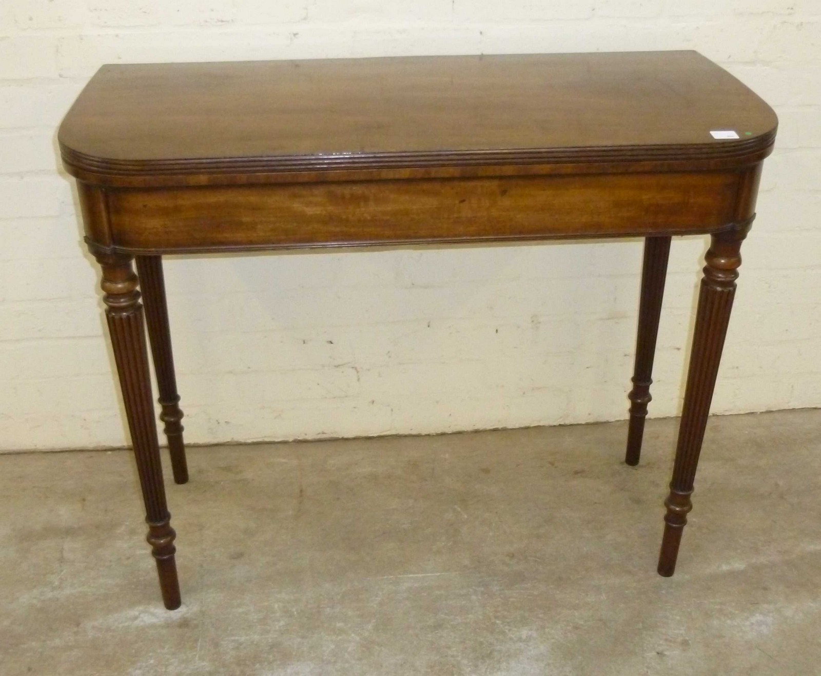 Good quality mahogany fold over card table with tapered fluted legs