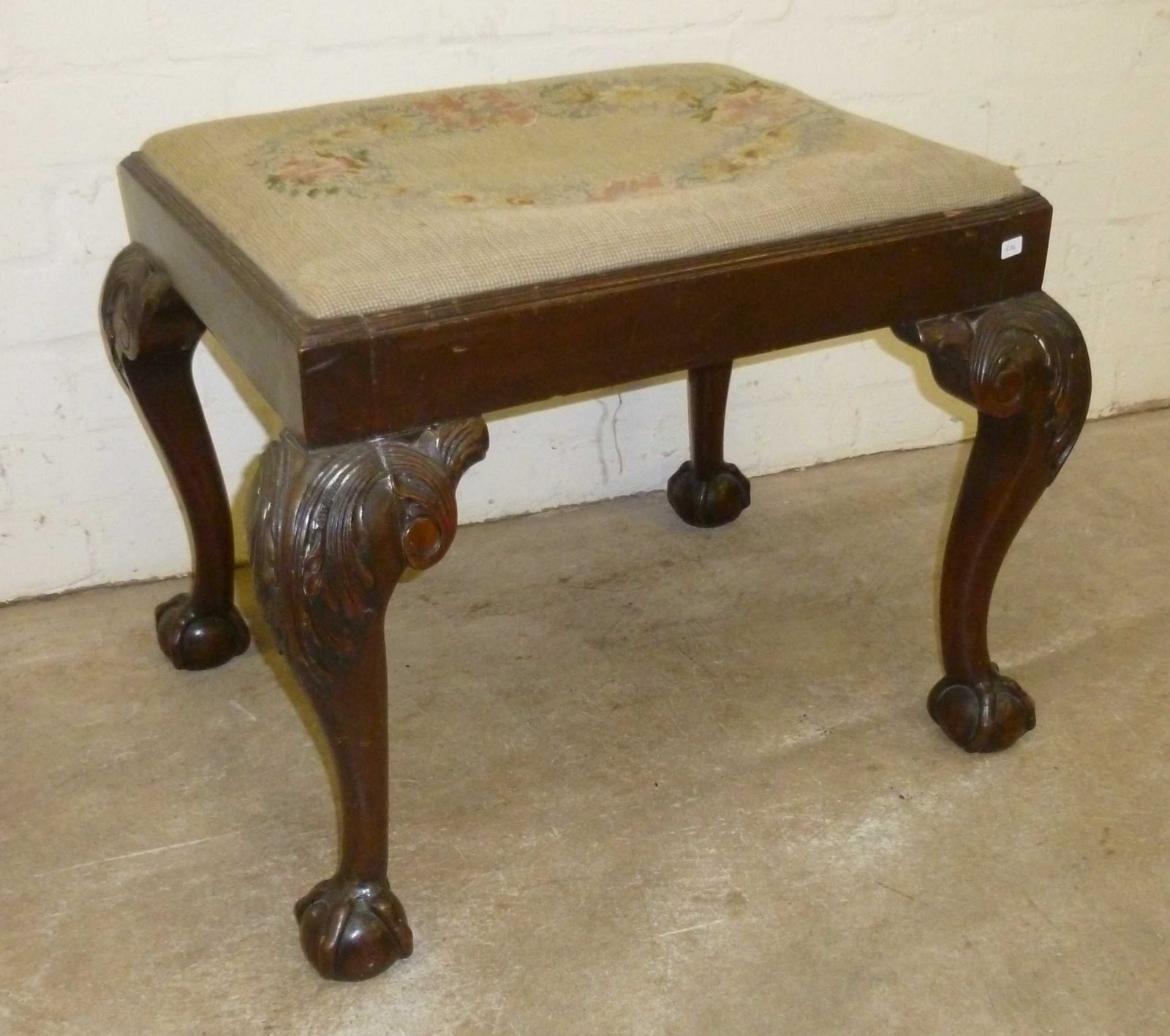 Tapestry topped stool with carved ball and claw legs