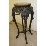 Heavily carved jardinaire stand with inlaid granite octagonal top