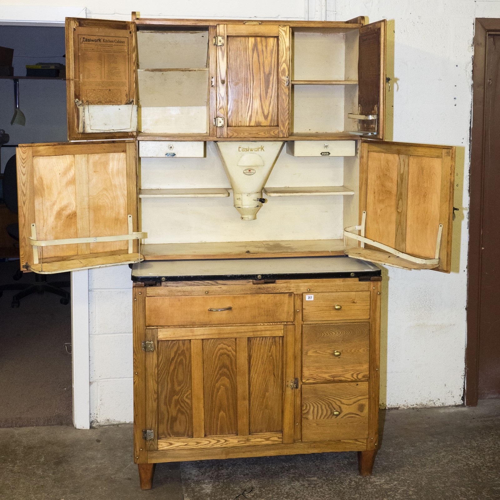 Restored Easiwork 1920s kitchen cabinet with original labeling, flour hopper, egg drawer, icing