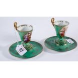 Pair of continental porcelain cabinet cups and saucers having decorated panels and gilt highlights