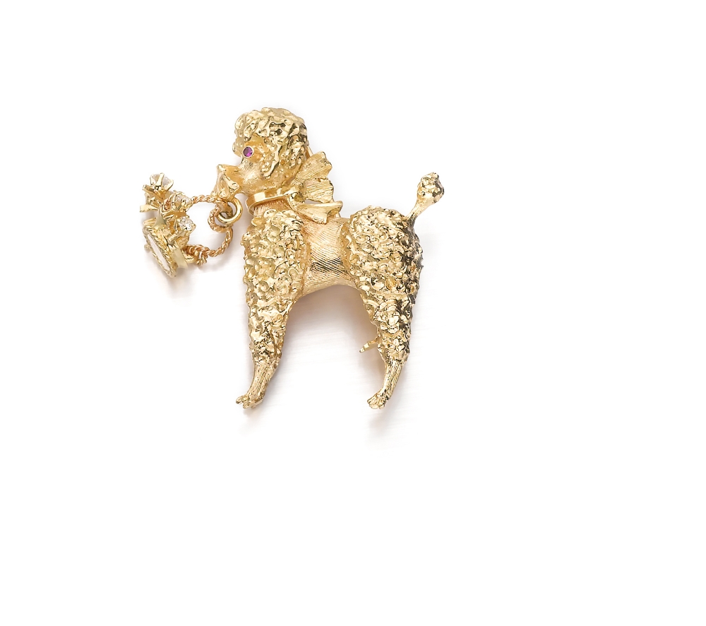 An Amusing "Poodle" Clip Designed as a sculpted and chiseled little dog holding a small basket,