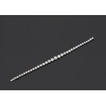 A Diamond Line Bracelet Designed as a graduated line of bezel-set old-cut and circular cut diamonds,