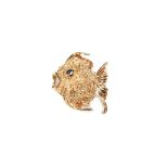 A Fish Brooch Designed as a textured scale fish set with a sapphire eye, mounted in 14k yellow