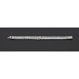 A Diamond Double-Line Bracelet Designed as two lines of baguette and circular-cut diamonds,