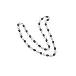An Onyx And Rock Crystal Long Chain Necklace Designed as an oval-cut spectacle-set faceted onyx