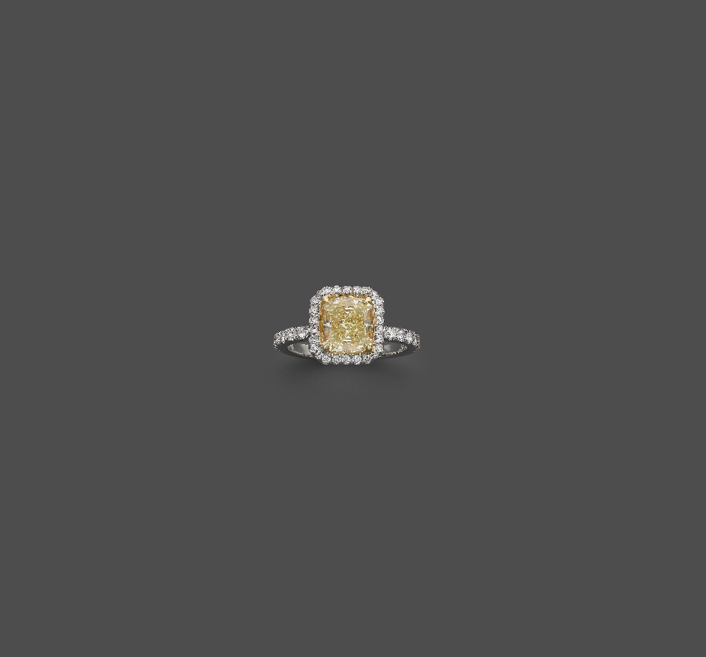 A Fancy Light Yellow Diamond Ring Set with a cushion-shape fancy light yellow diamond, weighing 2.12