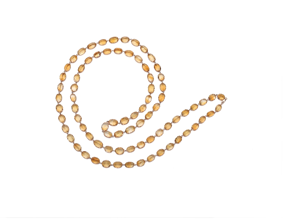 A Citrine Long Chain Necklace Designed as an oval-cut spectacle-set citrine long chain, mounted in