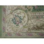 A large lime green ground Indian Carpet,