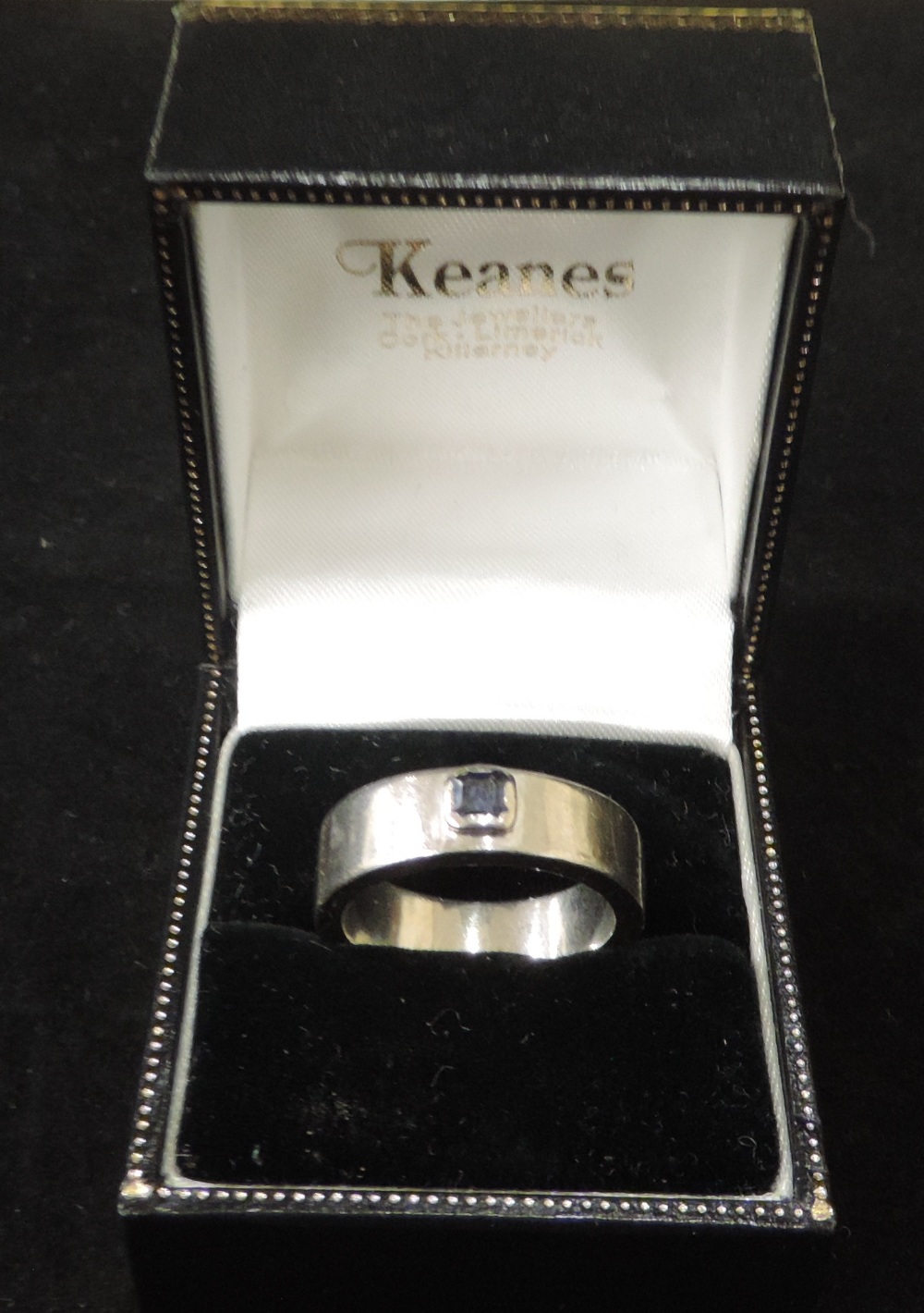 An 18ct white gold thick band Ring, with