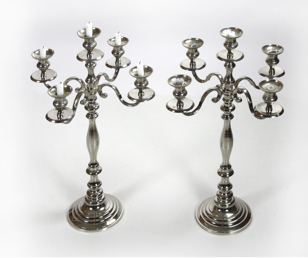 A pair of tall heavy silvered five light