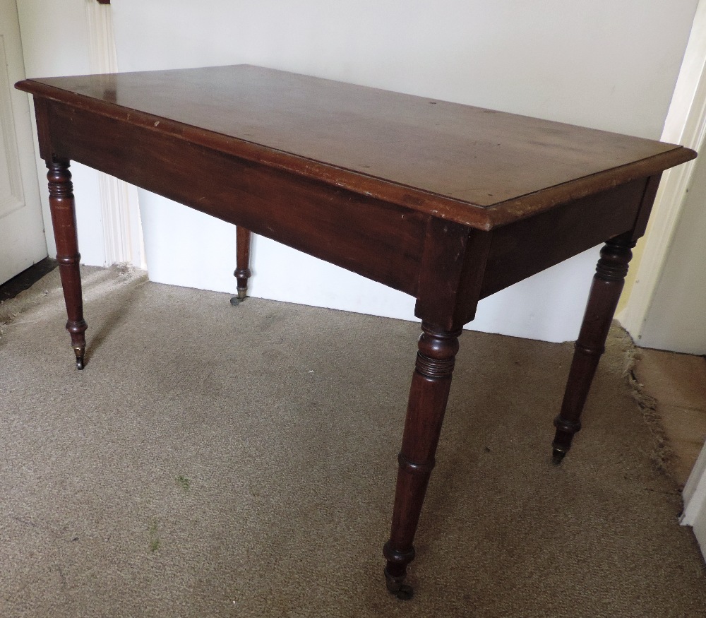 A mahogany Occasional Table, on four tur
