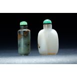 TWO CHINESE SNUFF BOTTLES. Nineteenth century. Jade in natural brown and black with a green stopper,