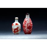 TWO CHINESE PEKING GLASS SNUFF BOTTLES. Nineteenth century. Red flowers in white background. Ruby
