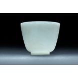FINE CHINESE CARVED WHITE JADE CUP. Nineteenth century. Translucent vessel with steep walls and thin