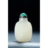 CHINESE GLASS SNUFF BOTTLE. Eighteenth-19th century. Carved pineapple skin body, with a jadeite