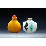 TWO CHINESE PEKING GLASS SNUFF BOTTLES. Twentieth century. Yellow with red stopper and white with