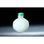 CHINESE WHITE NEPHRITE JADE SNUFF BOTTLE. Late 19th century. Carved sides. Green stopper. 2.25"h.