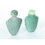 TWO CHINESE JADE SNUFF BOTTLES. Twentieth century. Green bottles with carved mask handles. 2.5"h.