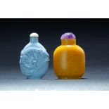 TWO CHINESE SNUFF BOTTLES. Twentieth century. One is yellow glass with stopper, another is blue