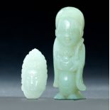 TWO CHINESE JADE BUDDHIST CARVINGS. Late 19th-early 20th century. Standing figure of a smiling god