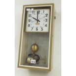 Brillie electric wall clock, the 6" square white dial within a glazed light brown metal case with