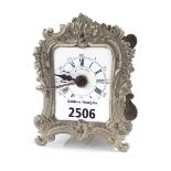 Small French white metal alarm carriage timepiece, the white dial within an ornate foliate glass