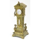 Novelty brass mantel timepiece in the form of a longcase clock, the 2.25" white dial within a